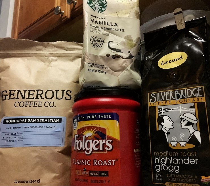 Packages of Generous Coffee Co coffee, Starbucks vanilla coffee, Folger's and Silver Bridge Coffee