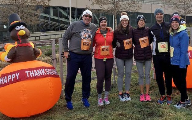 My family posing for a picture next to an inflated pumpkin decoration