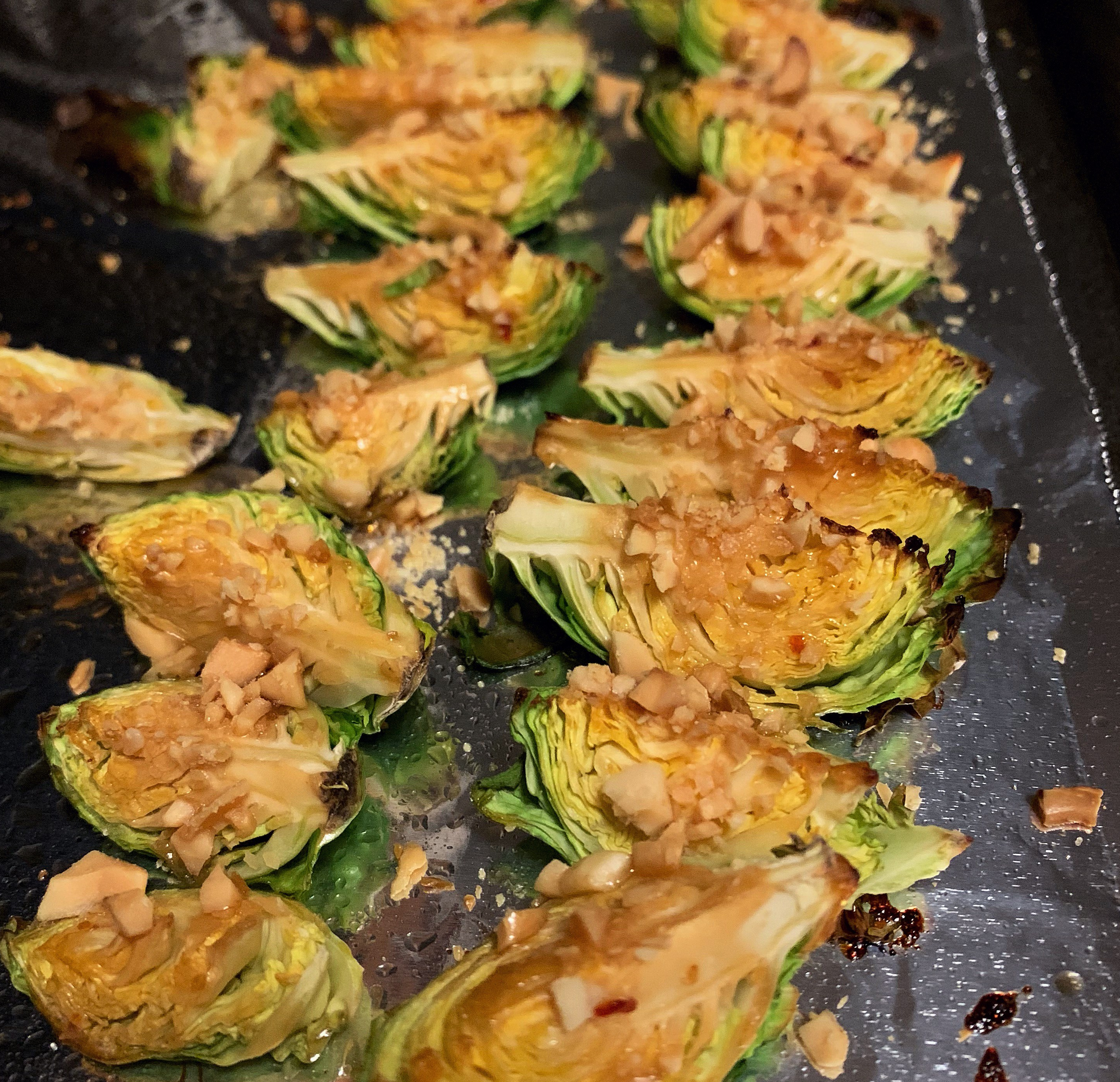 Roasted Brussels sprouts with crushed nuts and General Tso's sauce