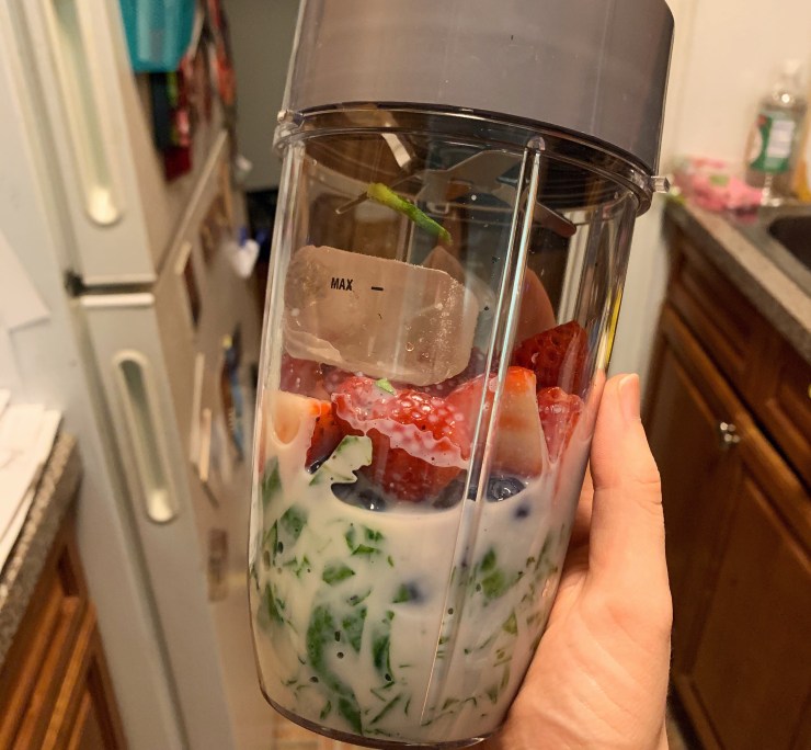 NutriBullet with fruit and veggies inside