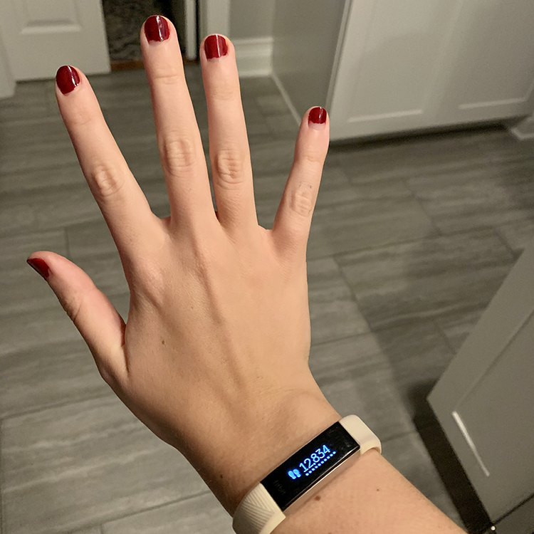 Fitbit Alta HR watch displaying 12,834 steps